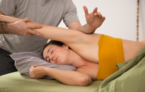 Rolfer rolfing shoulder sidelying in Los Angeles